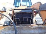 Close-up of a bulldozer's front grille with a blurred background